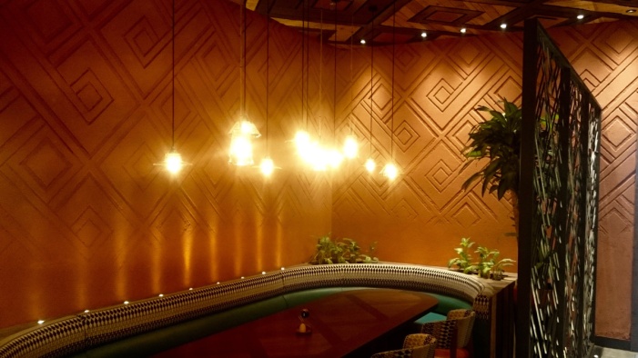 Carved clay wall by Guy Valentine at Nando's restaurant in Dubai.