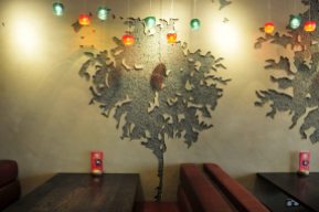 Carved clay tree images, Nando's restaurant in Wales Llanelli